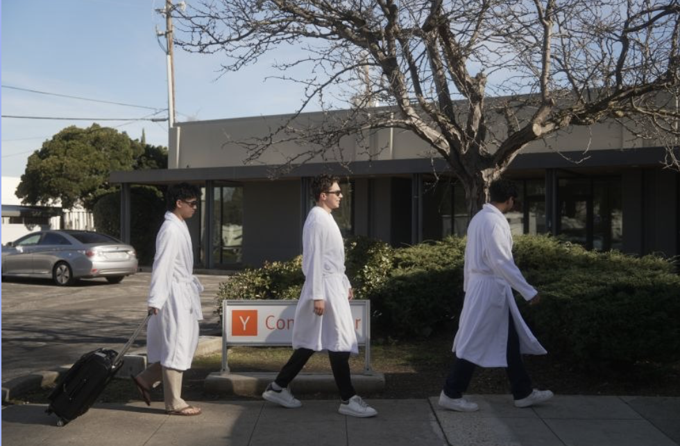 Caleb Chan, Gatik Trivedi, and Gavin Brennen walking in front of Y Combinator